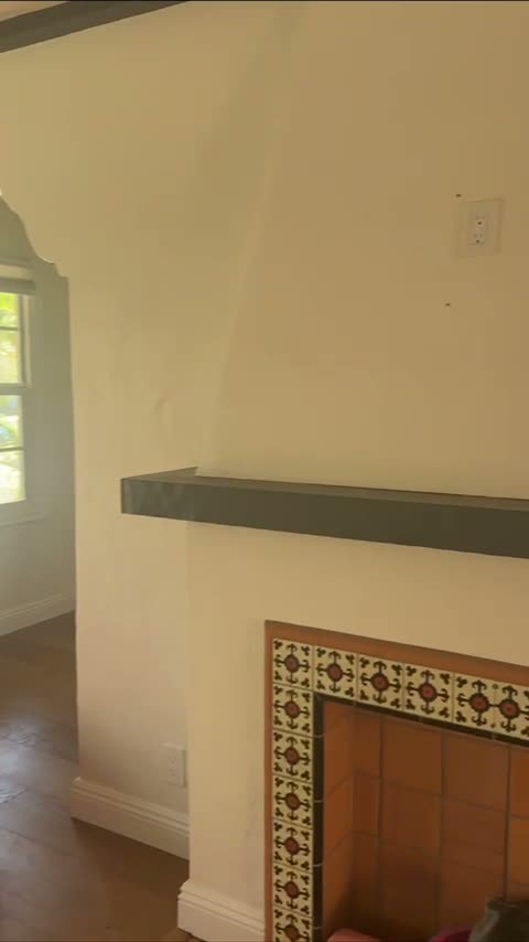 Current 1257 living room fireplace with tiled surround and dark mantel